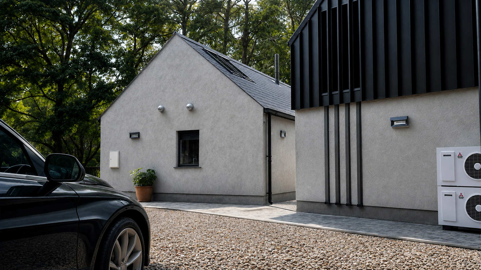 Modern black-and-white contemporary home by Usonia Architects in Donegal, featuring a pitched roof, solar panels, large glazing, and landscaped garden surrounded by mature trees.